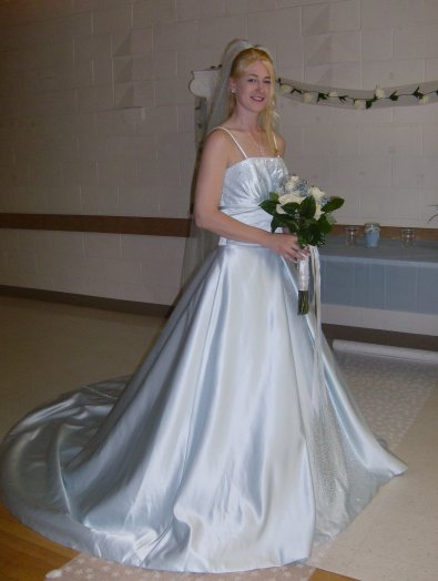 Heidi is breathtaking in her pale blue wedding dress.