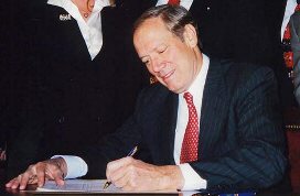 Picture; Governor George E. Pataki signing bills S674b/A1131b, PINS runaway /return bills, up to age 18 into law.