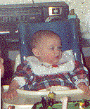 Emily in Feeder Seat on First Birthday