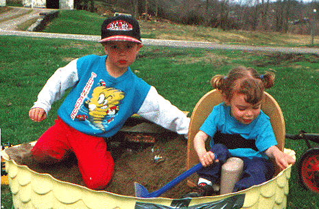 Emily in her corner chair in the sandbox with Jimbo