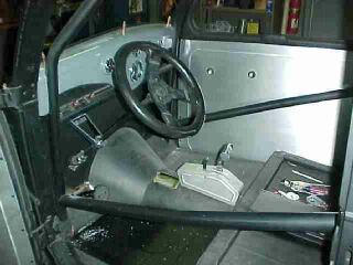 Column drop and u-joint allow steering to swing away for increased entrance/exit room