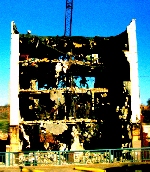 Destruction of 4 city blocks surrounding the author's home, making way for maximum-security prison to replace city and county jails. � John Lee