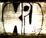 Ghetto graffiti in alley where author's car stolen. � John Lee