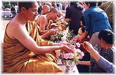 alms giving to monks and giving/receiving holy water are integral parts of the Lao lunar new year celebration 