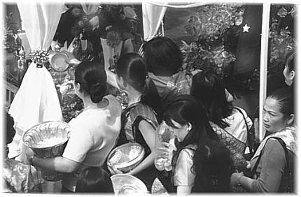 dousing the Buddha statues with holy water - this is a good time to wish all your worries away as you pour the water