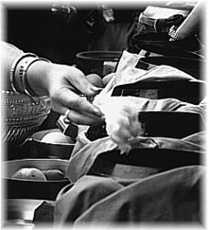 a 'close up' on alms giving at the temple - part of a Lao New Year celebration