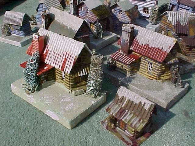 Note the chimneys on these otherwise identical LOGGIES" - one is actually a "PRINTIE" - pretty much tying them to the '29-32 period.. Both of these have glossy sides and rich colors. The litle guy with stick-on window in the lower right is actually a candy-box, which you have seen before. 