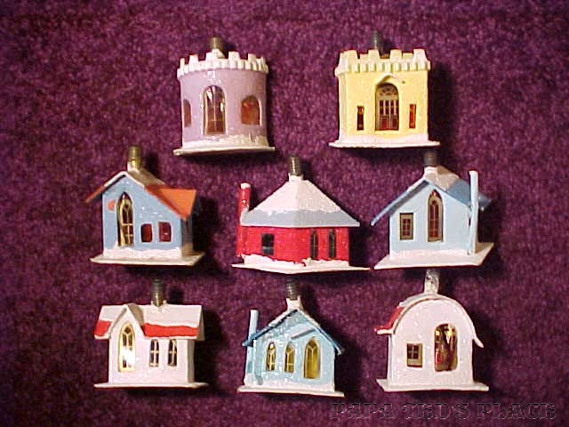 NIPPIES from "Nippon," meaning "Japan" in their own language. This is another singularity from the '30's: novelty C-6 series light bulbs with mini cardboard houses built around them. I have never seen seen a boxed set, but there are only 8 different kinds, and all are shown. ... the standard string of 8 C-6 lights in series. It's hard to find them in working condition, The enclosure of the bulb seems to have raised it's envelope temperature and this would greatly shorten the filament life. Then, it's impossible to replace the bulb without destroying the little house. The bulb was a special long-shank type, too, and the heat was not easy on the cellophane windows. I include them here as they are of interest to both house and light collectors. 