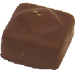 Flaky hazelnut praline on a nougat square and gold leaf