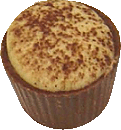Whitecoffee ganache in a milk cup with white chocolate and duted with cocoa