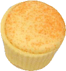 White mango ganache in a dark cup with with white choc and sprinkled with orange