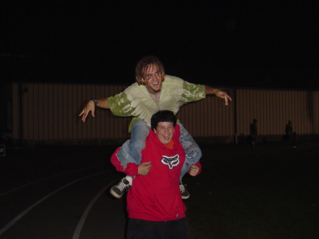 IM FLYING! Buttered popcorn!  Me on midget Justin kid's back at GC's game...