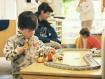 Tim playing with the train set at the daycare.  Note how he clutches trains to prevent other kids taking them.