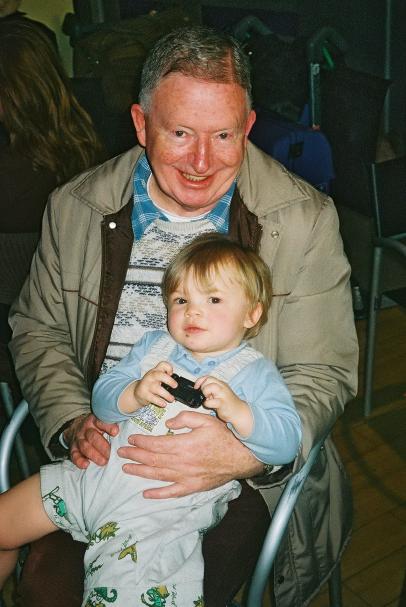 Jan 5, 2003.  Heathrow. Grandpa John holding Megan (on return leg of previous holiday trip!)