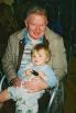 Jan 5, 2003.  Heathrow. Grandpa John holding Megan (on return leg of previous holiday trip!)