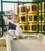 Feb 28? 2003, Oakland, CA. Megan climbing onto a playground slide.