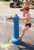 Granville Island, waterplay area.  The game is to squirt others while staying dry yourself...