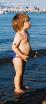 July 5.  Megan loves playing with wet sand at the waters edge, throwing it in the waves.