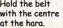 Hold the beltwith the centre at the hara.