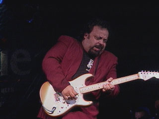 Otis plays guitar in concert.