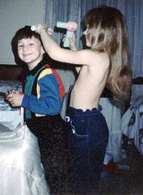 Amanda fixing Michael up with her new (toy) blow dryer (topless!) Look how long her hair was.
