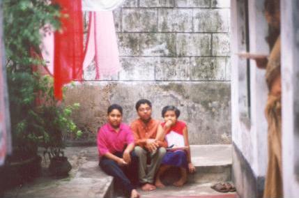 Three children sit on 'chatal' and discuss