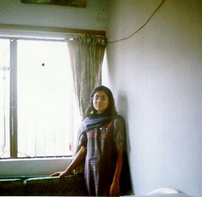 Sulagna standing near window in winter morning lights