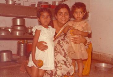 Rachana holds her 2 daughters for the snap