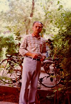 Mr. S. R. Das is standing&nbsp; in his&nbsp; garden.
