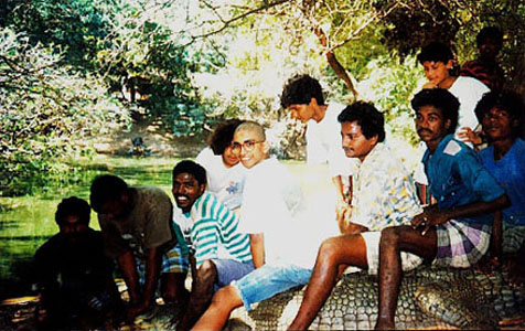 sitting on a crocodile before it was transferred to another enclosure