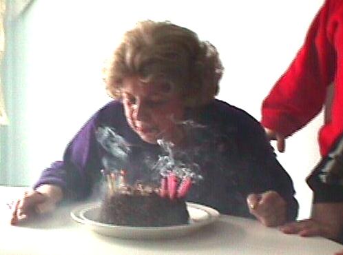 Mom W., blowing out candles