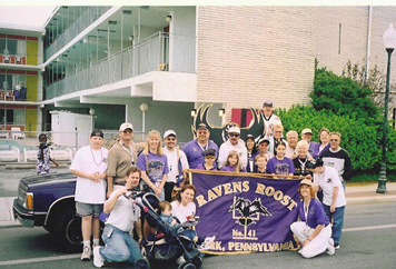 Members pose next to Roost #41 Ravens-mobile prior to the parade.