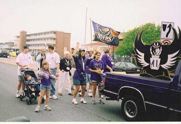 The Ravens-mobile leads the way as Roost #41 members follow with cheers.