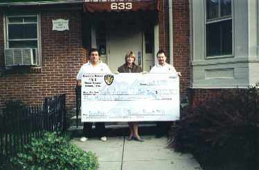 Roost members George Christas and Mike McGuigan  present a check to Access York