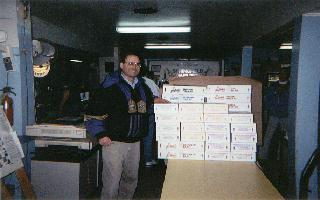Alan Epstein stands next to boxes of pizzas sold to benefit Access York
