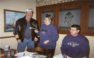 Board member Deb Morris takes care of business as John Siegmund looks on