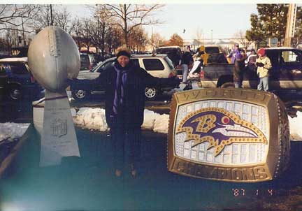 Roost #41 member Peggy Brandt poses with Super Bowl XXXV trophies.