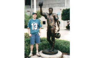 Greg Keilholtz stands next to his hero Dan Marino prior to the Ravens-Dolphins playoff