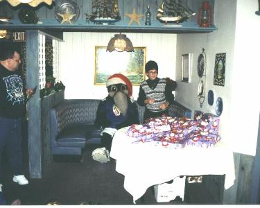 Ravens mascot Poe and Marianne Rupp prepare the gifts