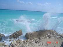Waves crashing on a broken retaining wall