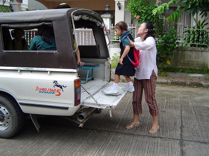 Emily getting into song taew (local school bus)