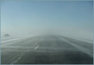 through the windshield near the airport on K-18, 11 AM, under clear skies...