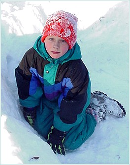 red-green-blue boy in a big snow...