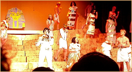 On stage: Elvis, Joseph, some hairy-legged stranger.