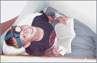 Taylor reading behind the dresser.