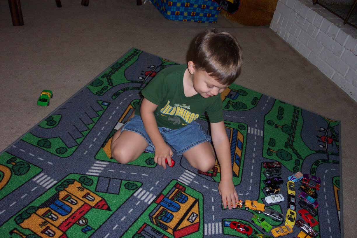Christian playing with his cars.
