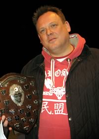 photo of Ralph holding the best cornet award