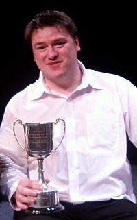 photo of Simon holding his best horn award