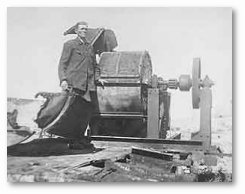 Moses Korn, a member of the Sonderkommando 1005 Unit, stanks next to a human bone crushing machine at Janowska Concentration Camp