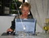 Sue sending an e-mail.. with a glass of wine by her side :)